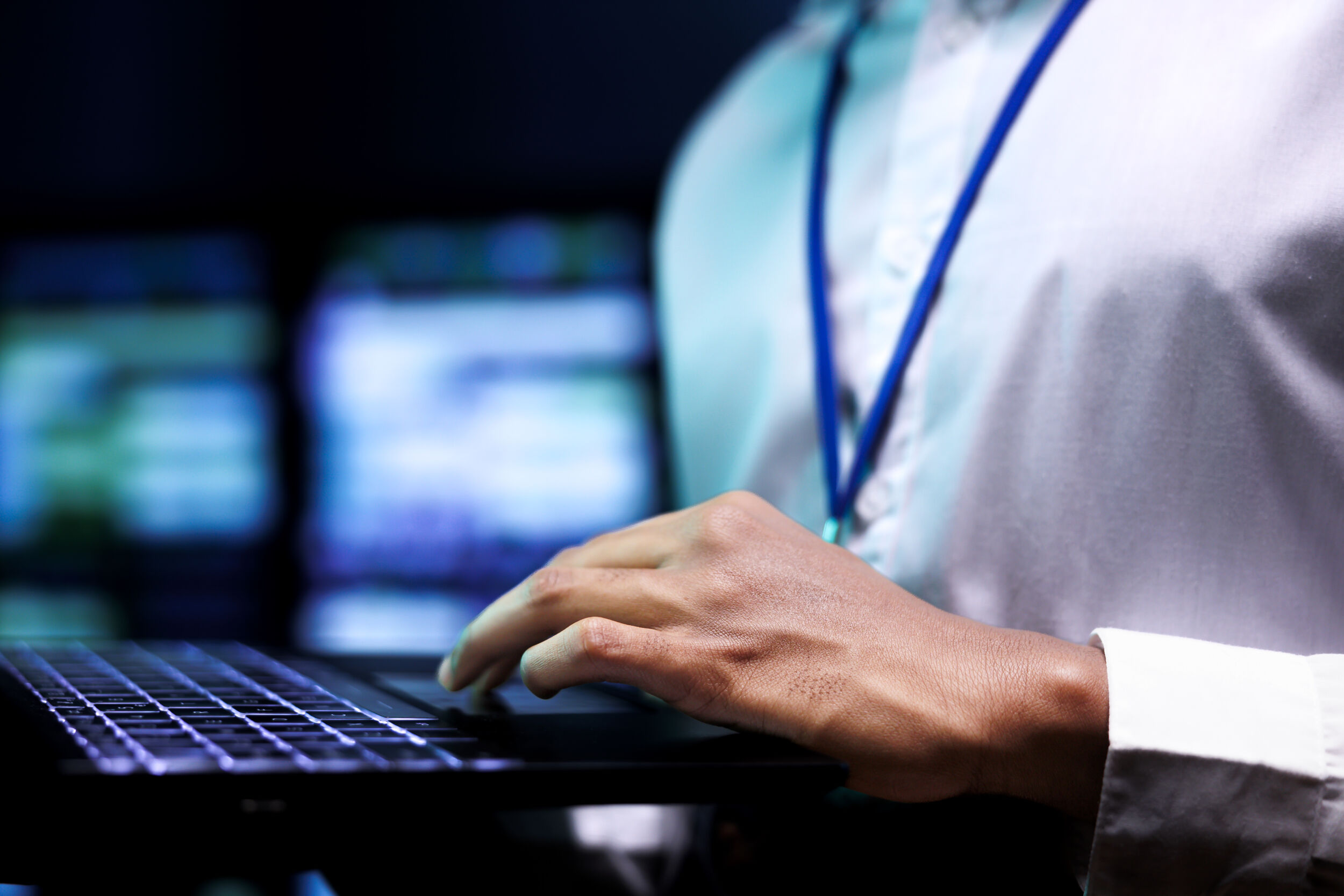 expert using laptop to analyze servers
